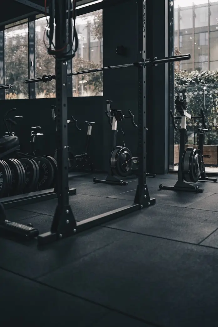 Quiet platform room with squat rack and stacked bumper plates