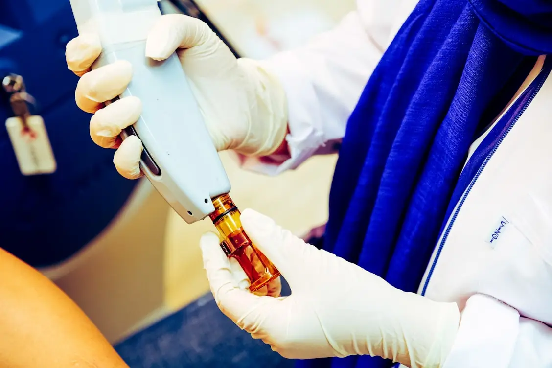 Provider preparing a handpiece before a laser treatment session